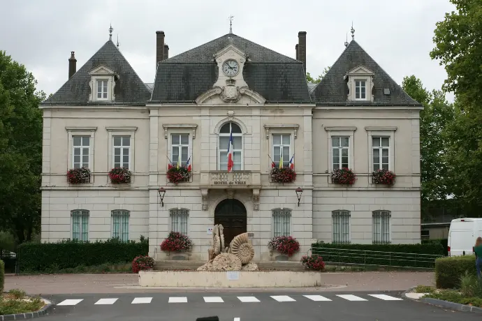 a large building with a fountain in front of it